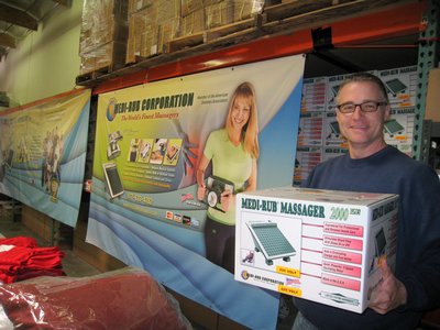 A Man Holding A Massager Box