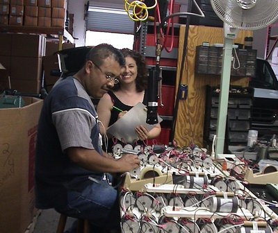 A Man And Woman Working On A Table With Massager Device